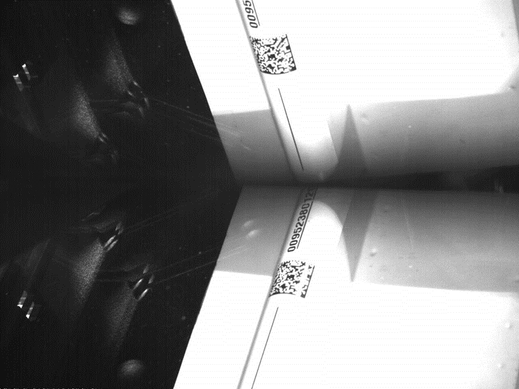 A photograph of a curved item on a bioptic scanner
